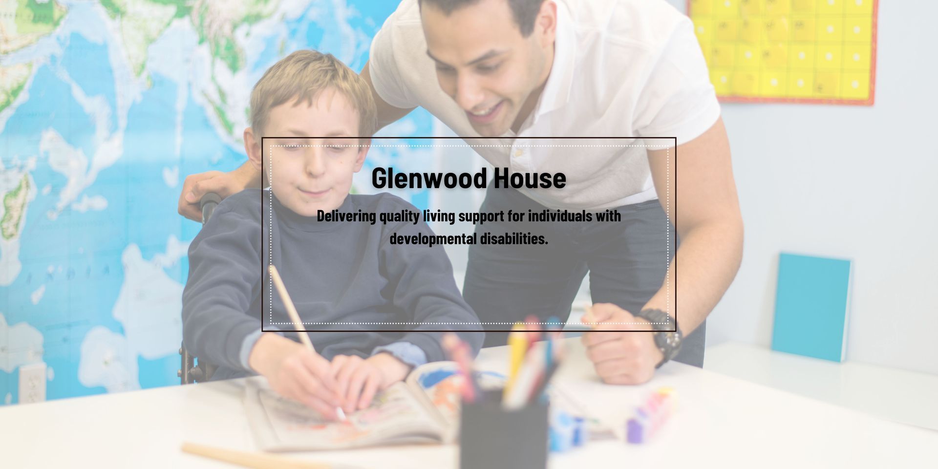 A man is helping a young boy with his homework.