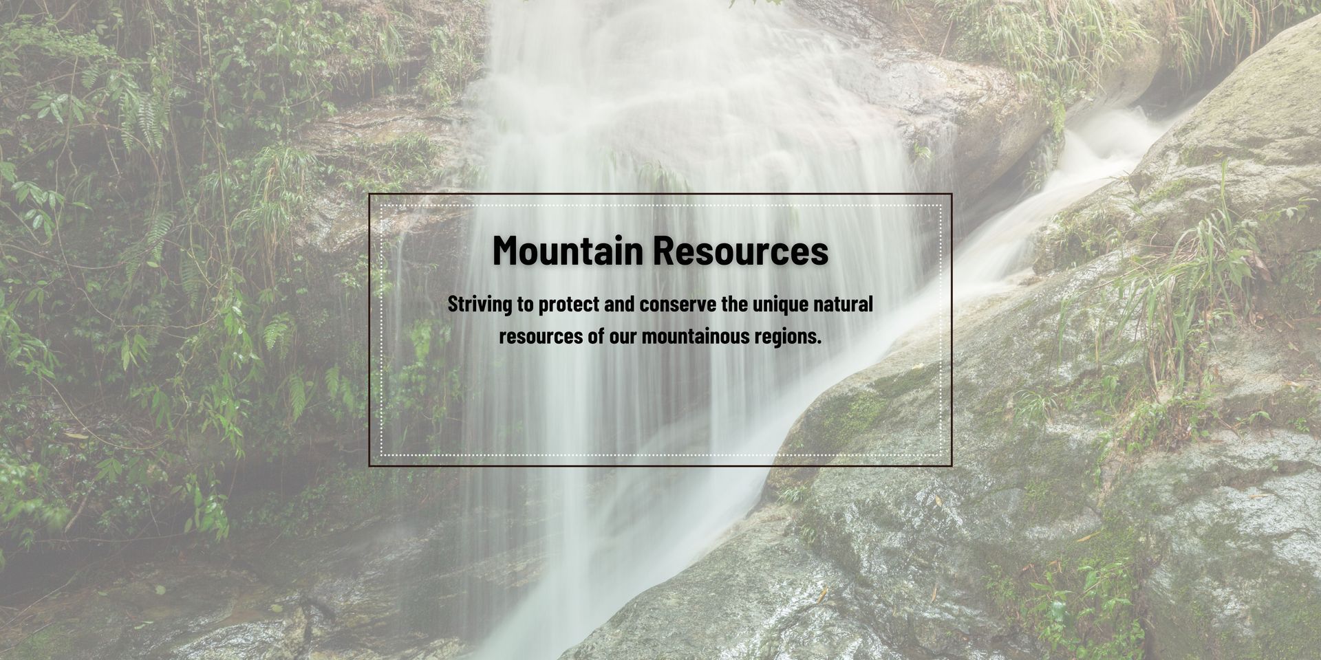 A waterfall is surrounded by trees and a sign that says mountain resources