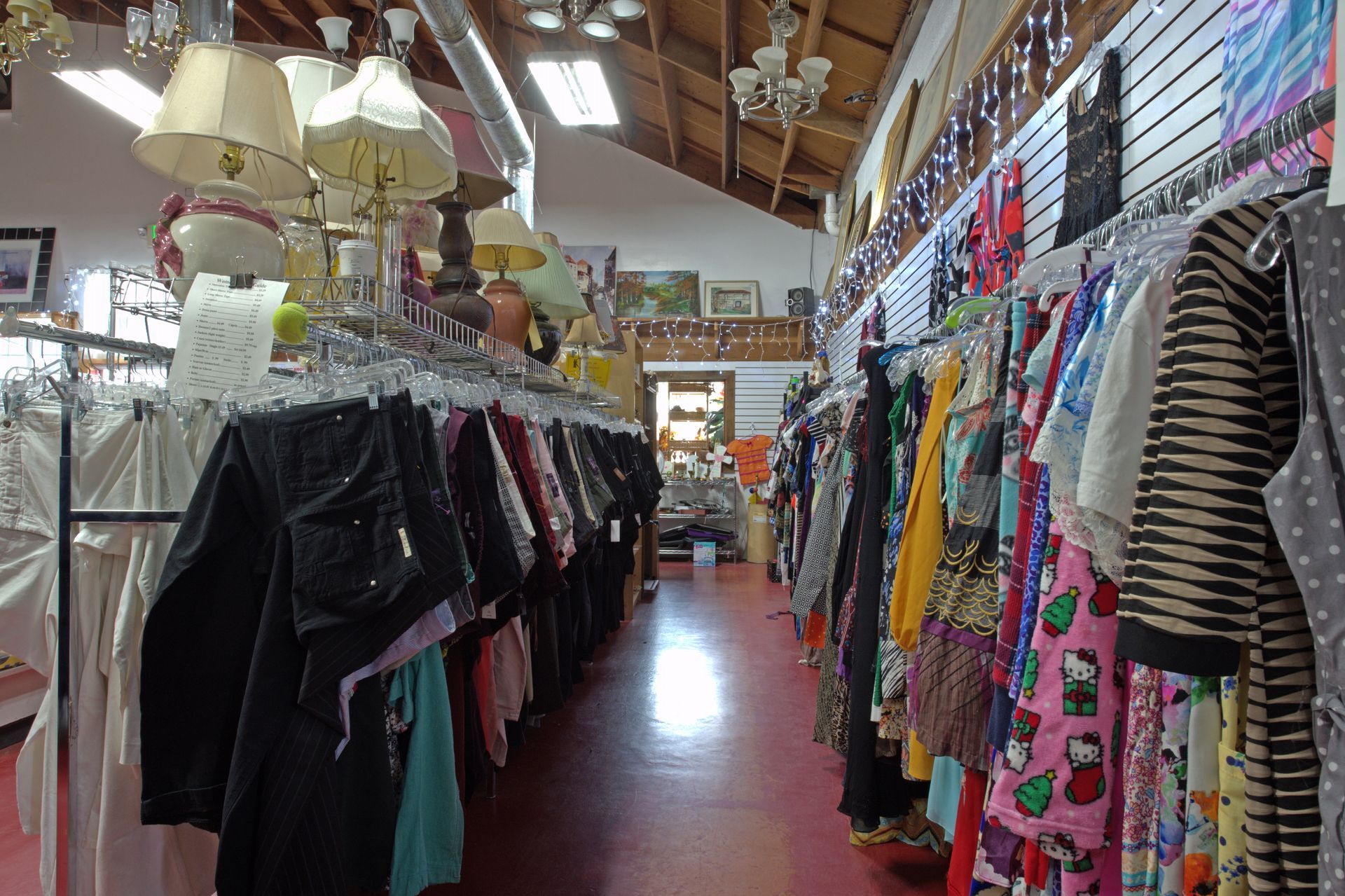 A store filled with lots of clothes hanging on racks.